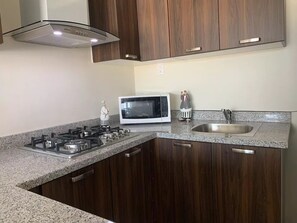 Fridge, microwave, stovetop, coffee/tea maker