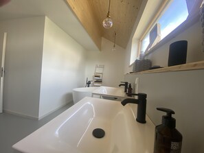 Bathtub, hair dryer, towels, soap