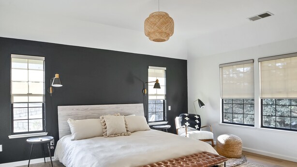 A bedroom with a large bed, a round ottoman, a bench, a small table, and two chairs. - The Ranch, West Sonoma County (Sebastopol)
