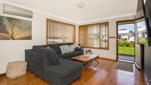 Relax in this stylish living room with a sofa, coffee table, and beautiful view.
