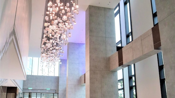 A spacious lobby with a modern chandelier, seating area, and large windows allowing natural light. - KSL Esplanade Hotel (Teluk Panglima Garang)