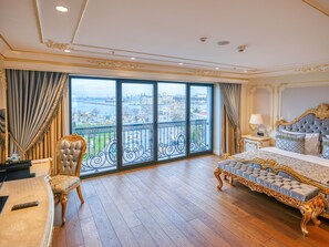 A luxurious bedroom with a large bed, a chaise lounge, and a view of a cityscape through floor-to-ceiling windows. - Dekalb Hotel (Istanbul)