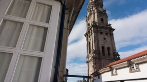 A historic building with a prominent clock tower and a white facade.