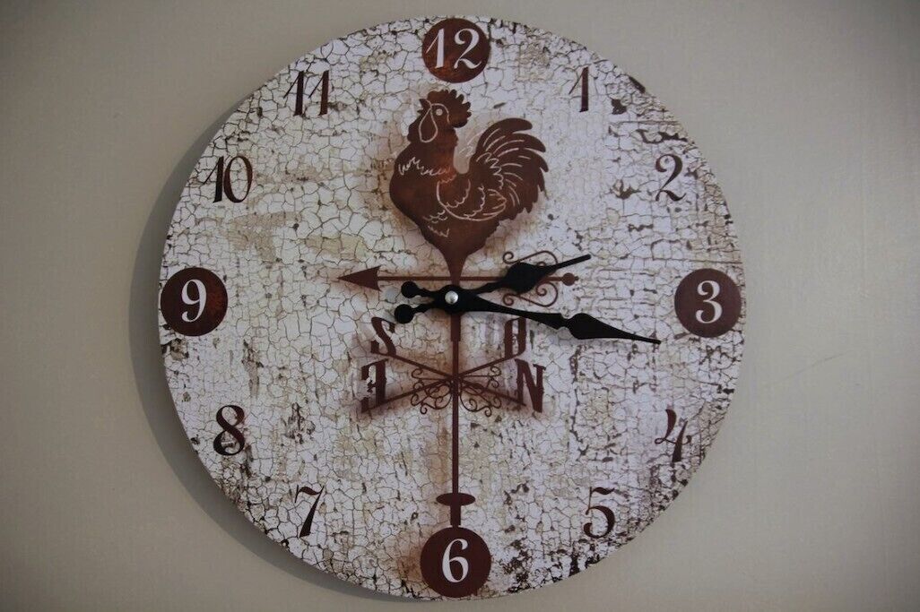Un orologio da parete rustico con motivo del gallo, con i numeri da 1 a 12 e una rosa dei venti.