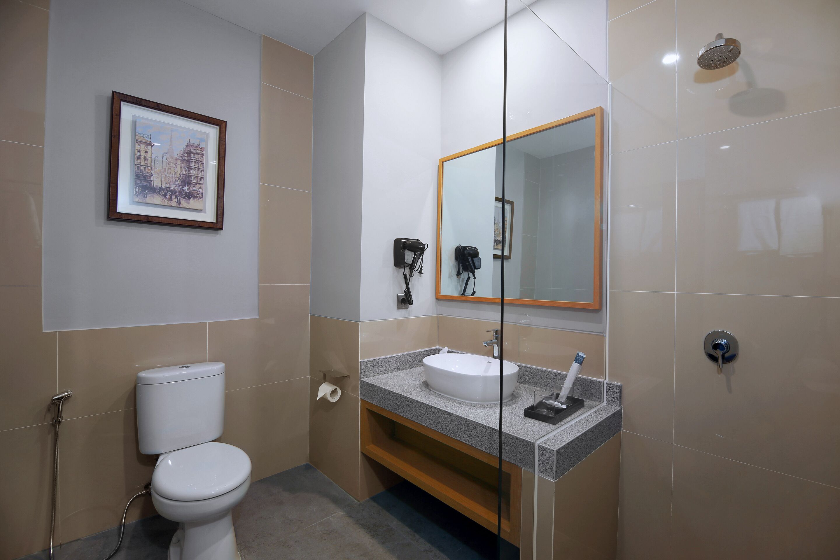 A modern bathroom with a toilet, sink, and shower.