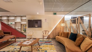 A modern lobby with a staircase, seating area, and a reception desk. - Blasco de Garay, double room with gym 118 (Madrid)