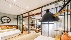A modern hotel room with a large bed, a desk, a television, and a large window with a view. - Design loft in CHUECA I4D (Madrid)
