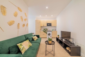 General view of the living room with the kitchen in the background