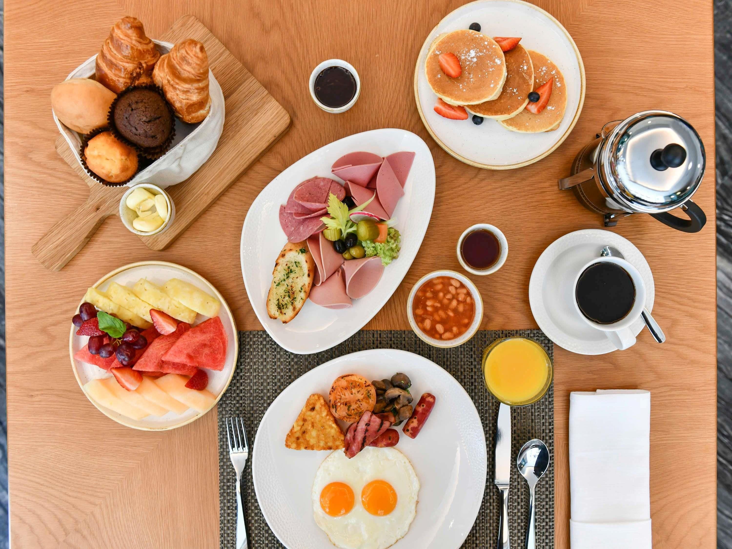 A breakfast buffet with various food items and beverages.
