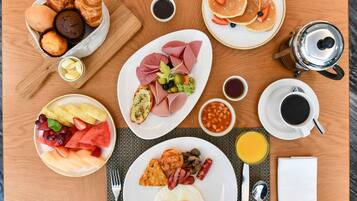 A breakfast buffet with various food items and beverages.