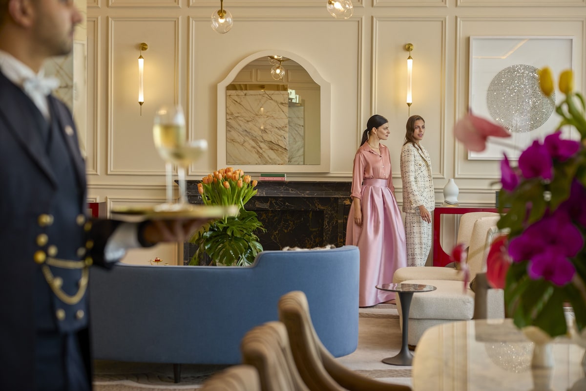A well-appointed lobby with a marble fireplace, elegant seating, and modern lighting fixtures.