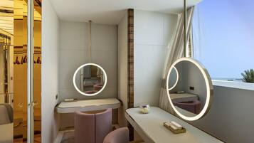 A modern bathroom with a vanity, two mirrors, a toilet, and a shower area.