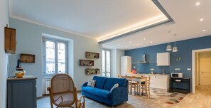 A modern apartment with a kitchen, dining area, and living room.