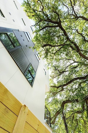 A modern building with a sloped roof and a large window. - Montrose Stay: 7 Rooms, 7 Baths & Rooftop Lounge (Houston)
