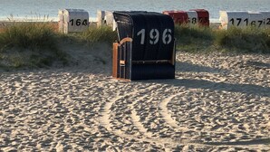 Une plage avec des cabanes numérotées, dont la cabane numéro 196.