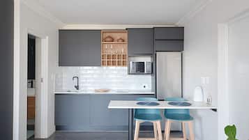 Full-sized fridge, microwave, stovetop, cookware/dishes/utensils