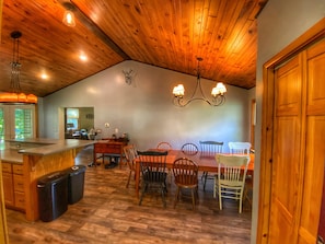 Enjoy meals in this elegant dining area with a long table and comfortable seating.