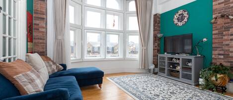 Basic Apartment, Multiple Beds | Living area | TV