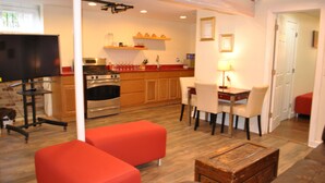 A modern kitchen with wooden cabinets, a built-in oven, and a dining area with a table and chairs. - WALKOUT BASEMENT NEAR downtown  Littleton Ave NEWARK NJ (Newark)