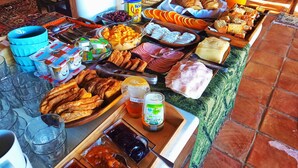 A buffet table with various food items and beverages.