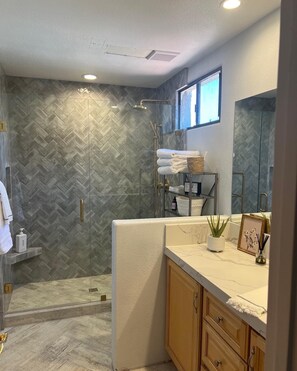 Bathtub, hair dryer, towels, toilet paper