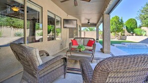 A covered patio area with wicker furniture, a ceiling fan, and a view of a swimming pool. - Hot Tub & Mtn Views! Family Getaway in Mesa (Mesa)