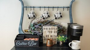 A coffee bar setup with a sign reading "Coffee Bar", a Keurig coffee maker, mugs, and a sign that says "WHEREEVER YOU GO". - LAKEHOUSE/HOT TUB/8 MILES TO DOWNTOWN/ON 60 ACRES (Indianapolis)