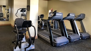 A gym with treadmills, elliptical machines, and a mirrored wall. - Ozark Retreat~Walk-In~Pointe Royale Resort~Pools/Hottub (Branson)