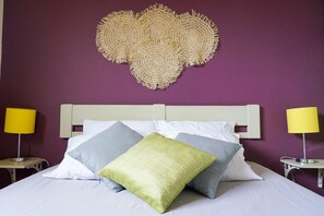 A bed with white bedding, a headboard, and two bedside lamps.
