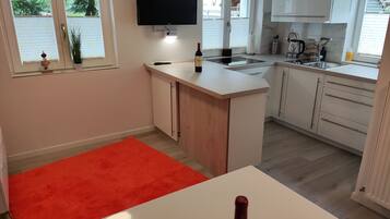 Fridge, stovetop, dishwasher, coffee/tea maker