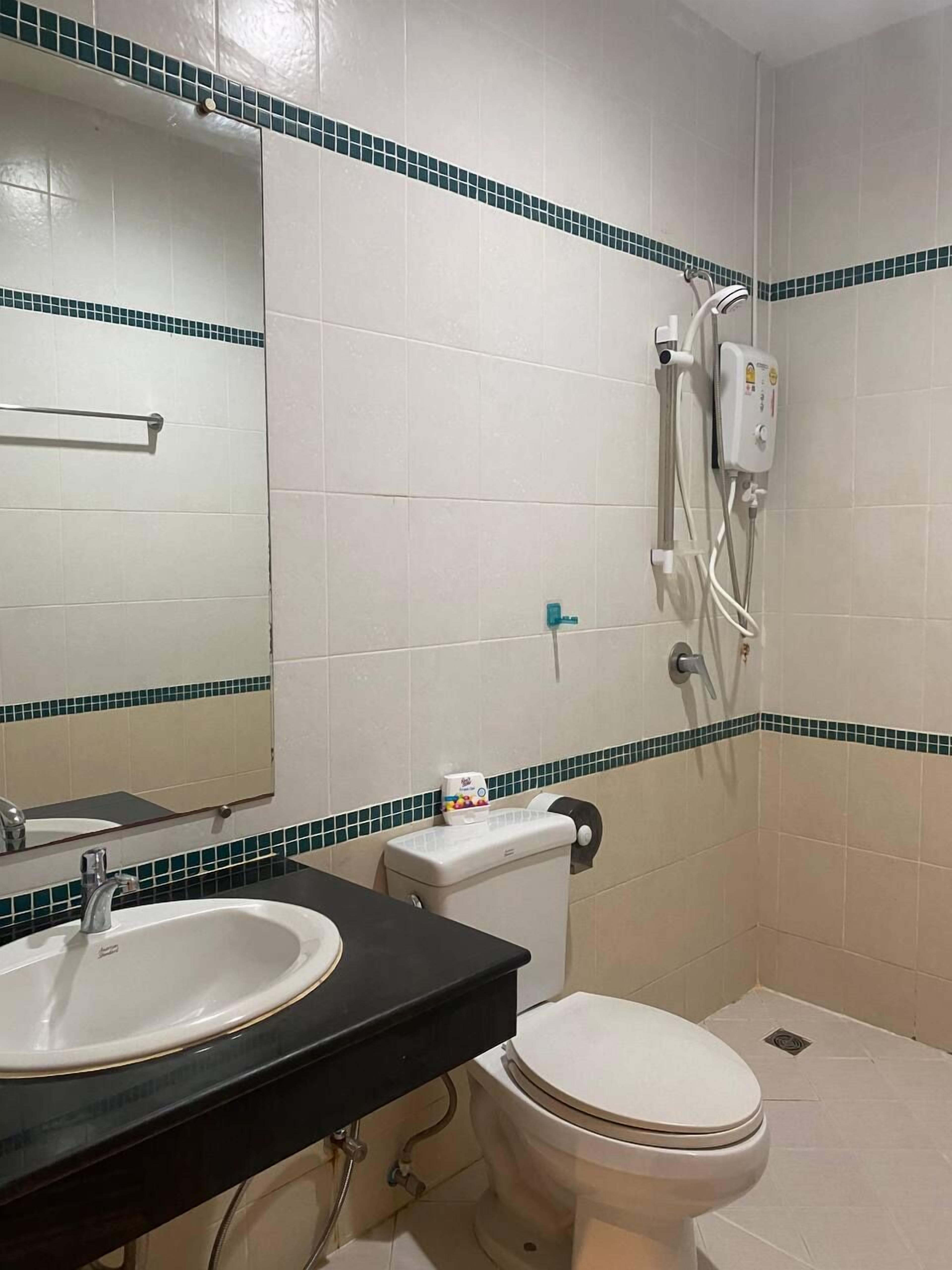 A bathroom with a sink, toilet, and shower.