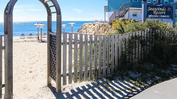 A gated entrance to Seawinds II Resort with a clear view of the beach and ocean. - Seawinds II (Dennis Port)