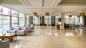 A spacious lobby with a polished marble floor, comfortable seating areas, and large windows offering views of the outside. - Wonder Palace Hotel Qatar (Doha)