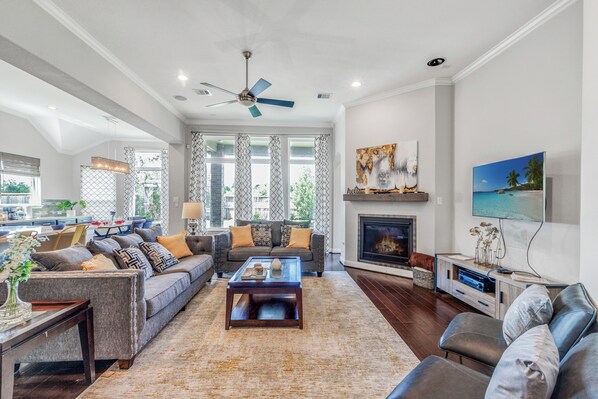 Smart TV, fireplace, books, computer monitors