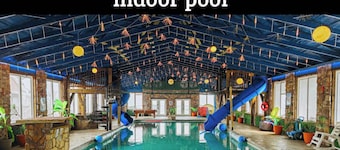 This is IT Cabin with a hot tub, fire pit, & indoor pool!