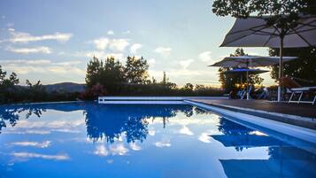 Relax by the serene pool surrounded by a comfortable deck and shaded areas.