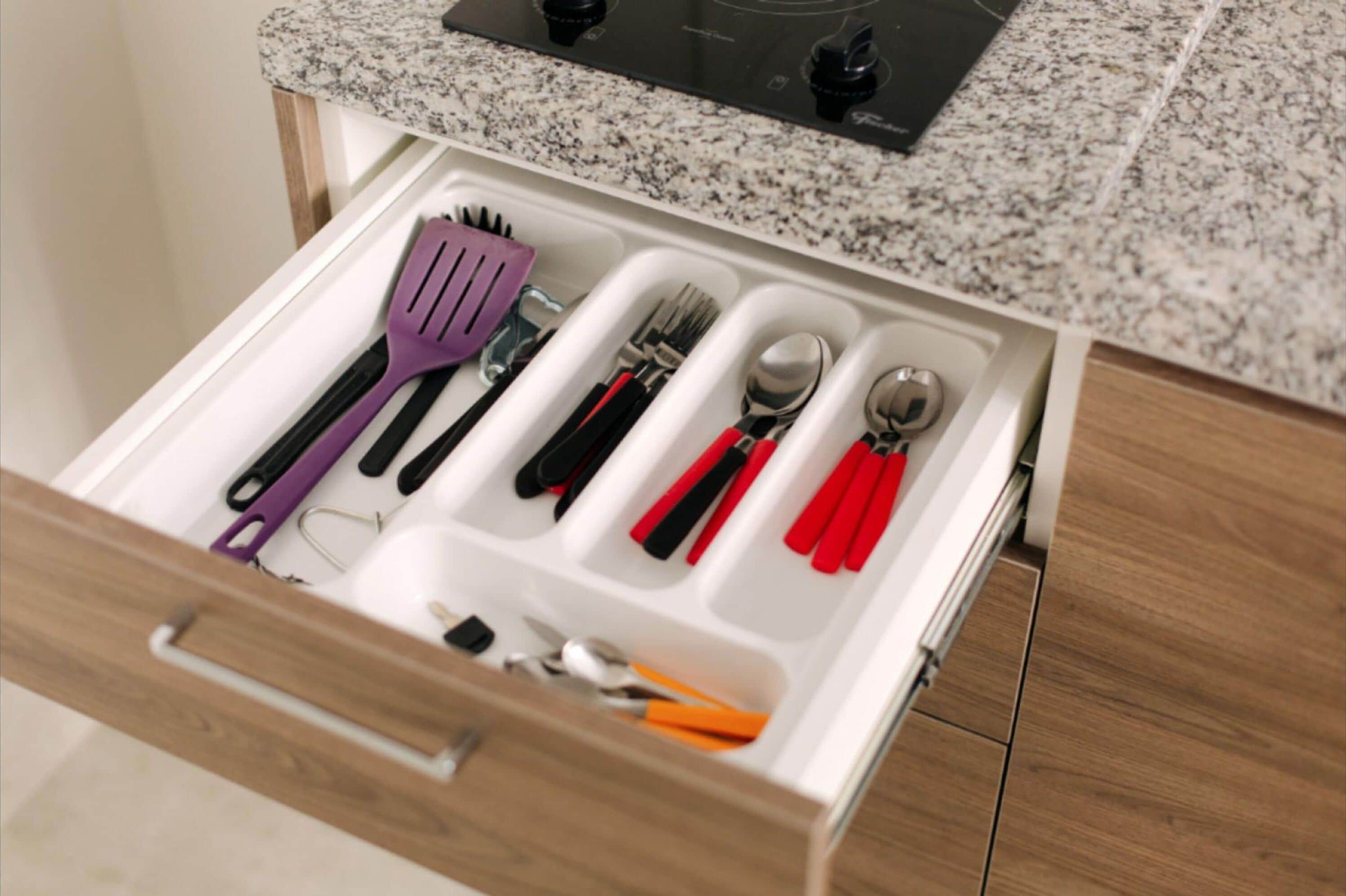 A kitchen drawer with utensils.