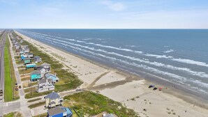 Une route côtière bordée de maisons et donnant sur une plage.