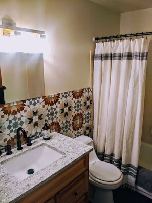 Bathtub, hair dryer, towels, soap