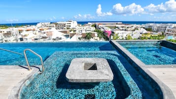Una piscina al aire libre, sillones reclinables de piscina