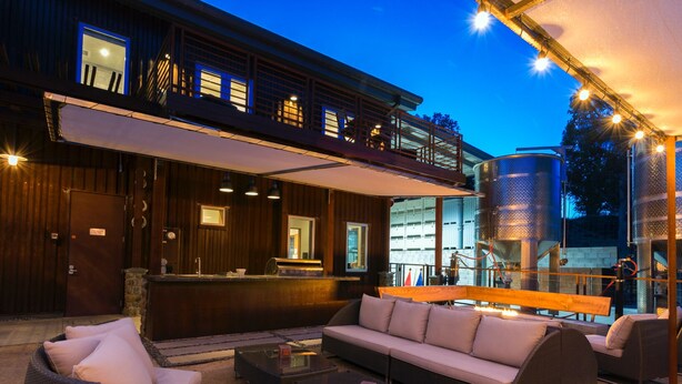 A modern outdoor seating area with a sofa, chairs, and a coffee table.