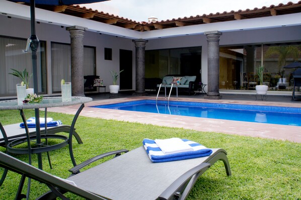 Outdoor pool, open 9:00 AM to 6:00 PM, pool umbrellas, pool loungers