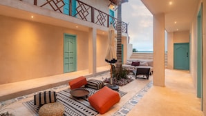 A spacious outdoor area with a balcony, seating, and a staircase leading to an upper level. - BACALARI HOTEL BOUTIQUE (Bacalar)