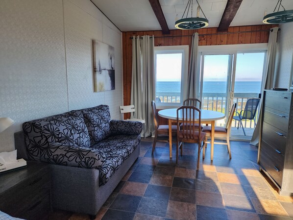 Family Quadruple Room | Living area | 32-inch flat-screen TV with cable channels