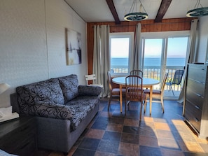 Family Quadruple Room | Living area | 32-inch flat-screen TV with cable channels