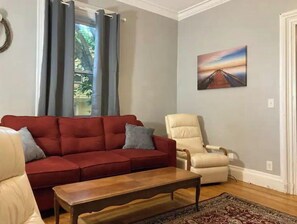 Relax in this inviting living room with a sofa, armchair, and coffee table.