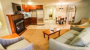 A living room with a sofa, a coffee table, and a fireplace. - Oceancliff Resort I & II (Newport)