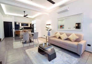 Superior Suite | Living area | 40-inch Smart TV with cable channels, heated floors - Instyle Residences at Rizz Suites (Sosúa)