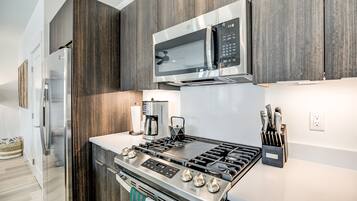 Deluxe Condo | Private kitchen | Full-size fridge, microwave, oven, stovetop