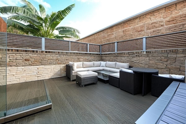 Private decked patio with comfortable seating and space to relax outdoors.